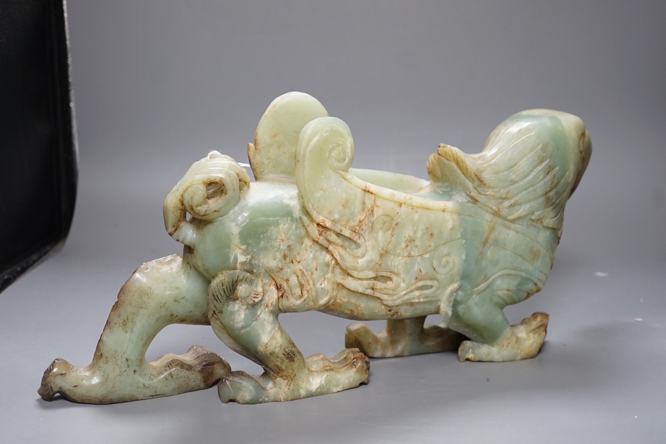 A large Chinese bowenite jade figure of a winged mythical beast, 46cm long